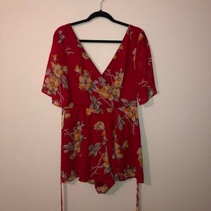 Red romper with yellow flower print and v neckline